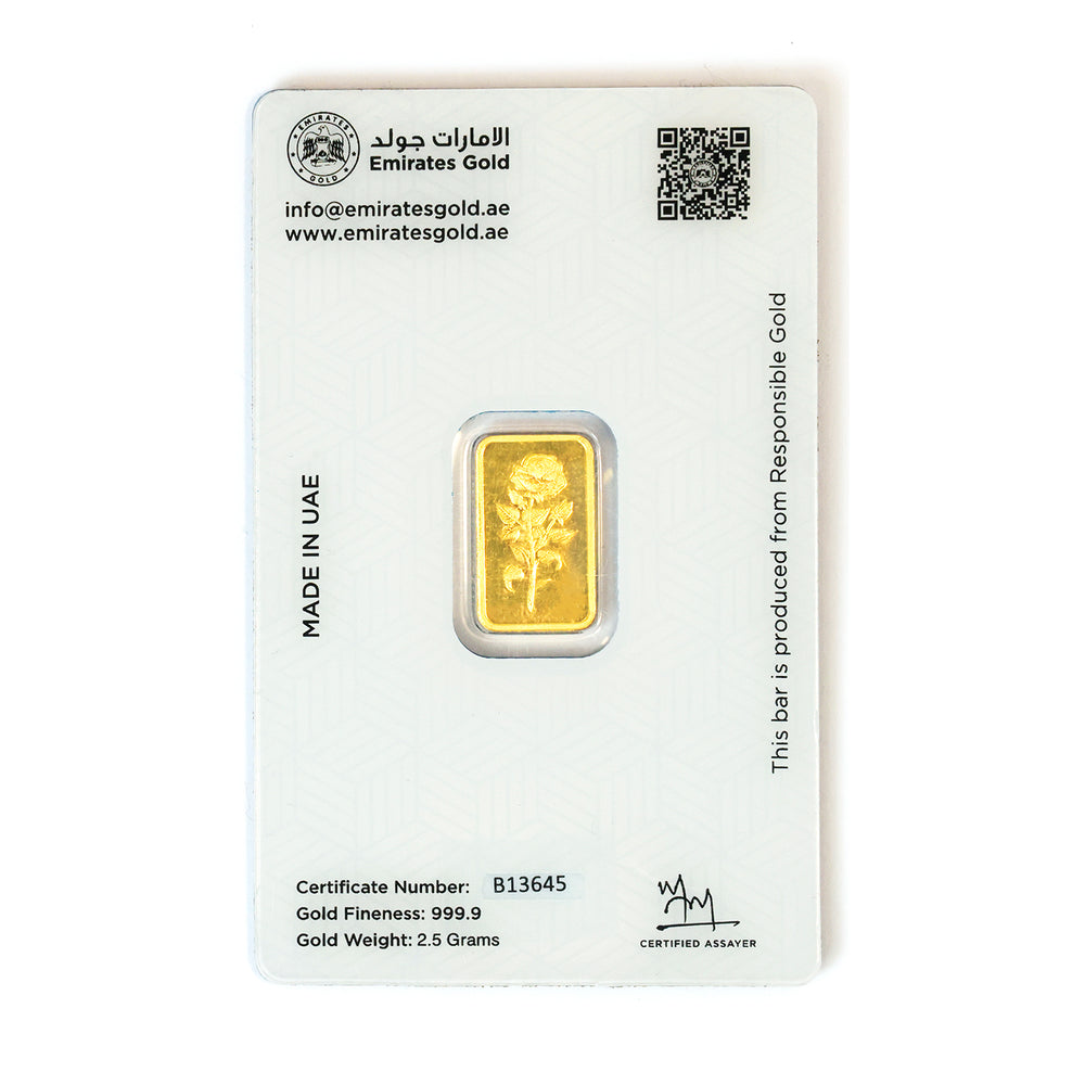 Gold bar with green butterfly charms on a white background
