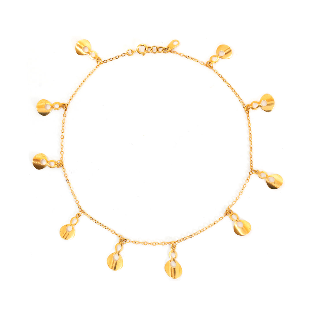 Gold bracelet with hanging charms on a white background