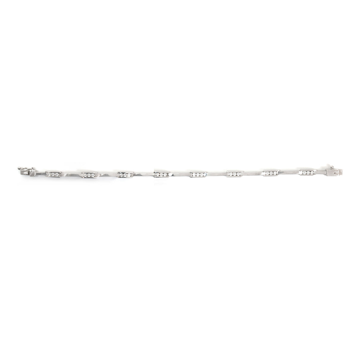 A delicate silver tennis bracelet with repeating oval links set with small clear stones, shown horizontally against a plain white background.