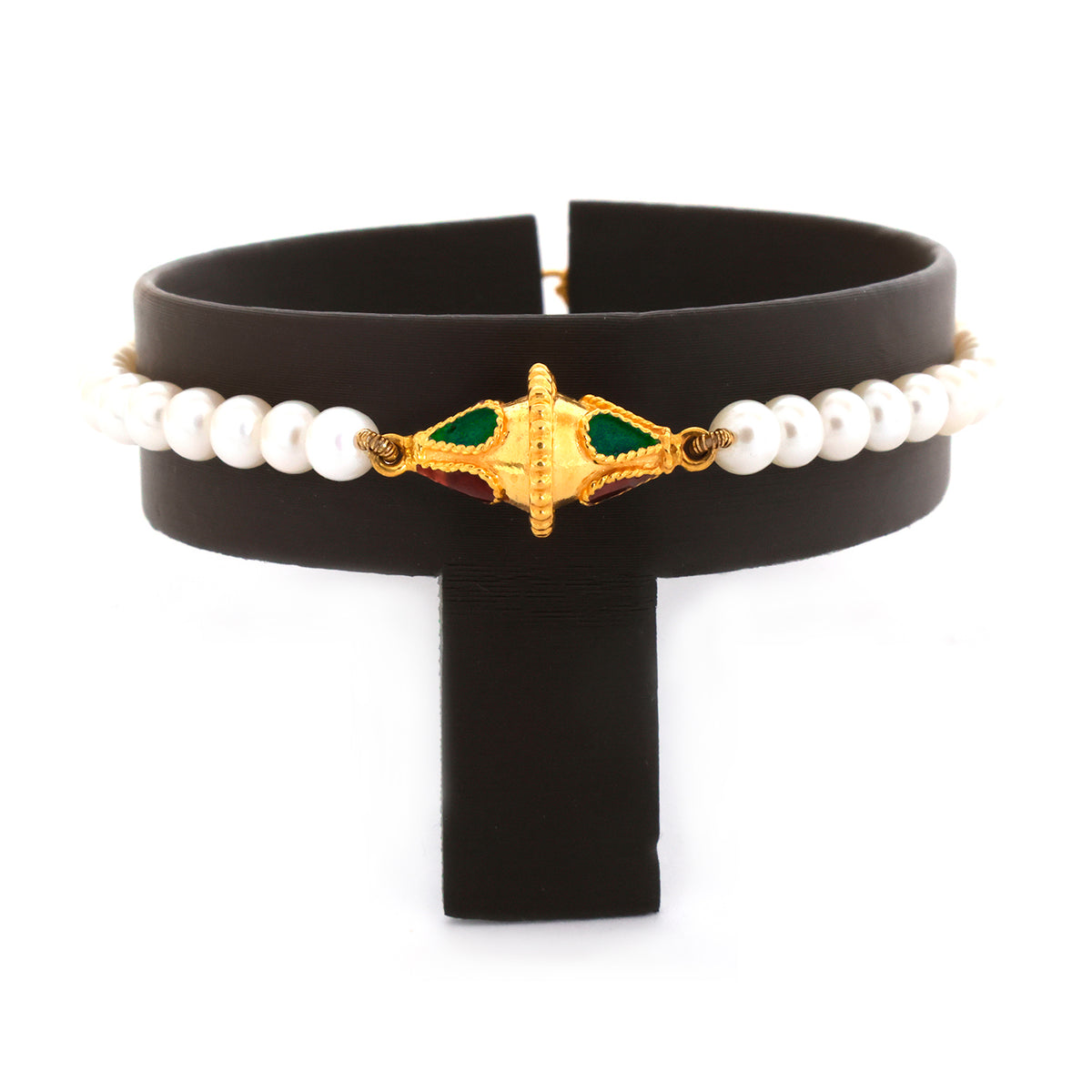 Black choker with pearl beads and gold and green decorative element on a white background