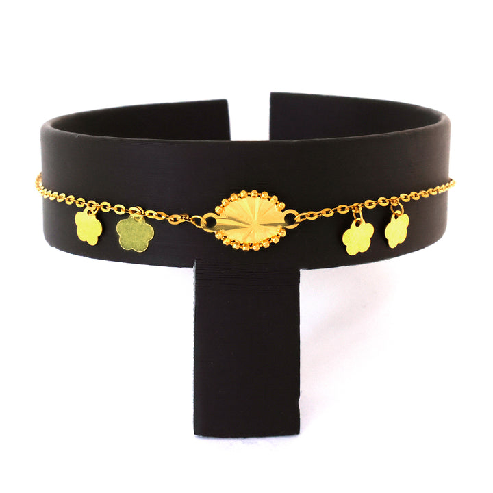 Black belt with gold chain and floral pendants on a white background