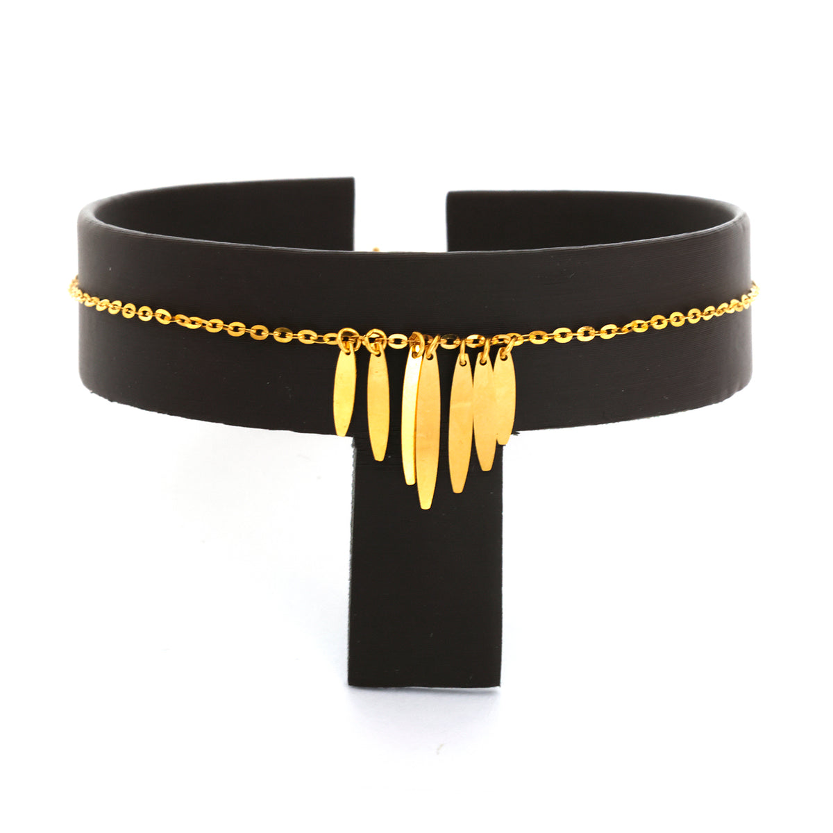 Black choker with gold chain and pendants on a white background