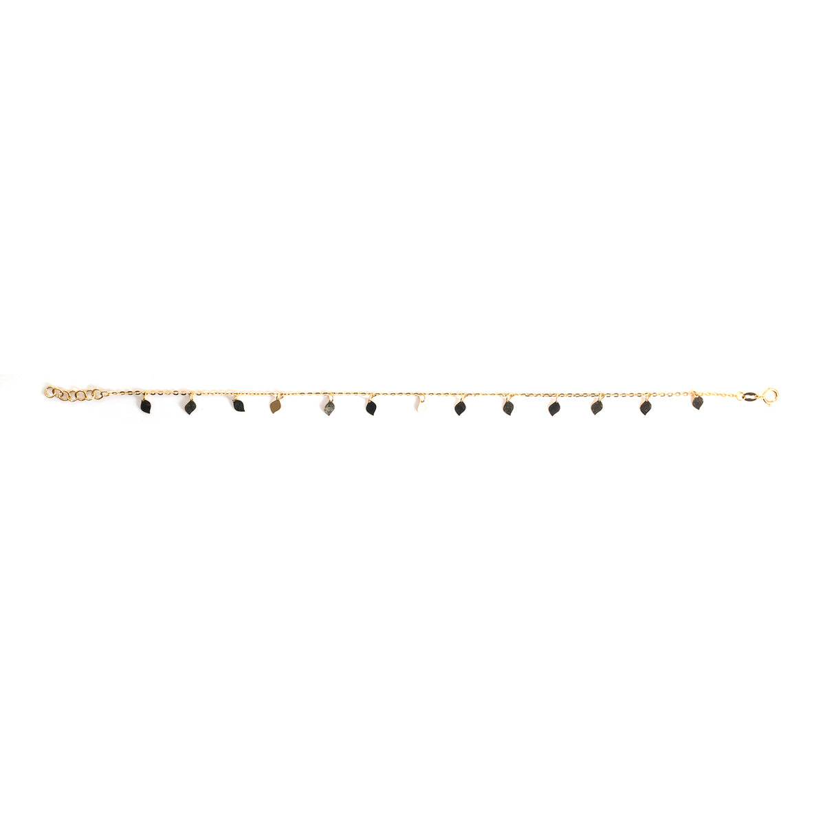 A delicate gold chain anklet featuring multiple small dangling black teardrop-shaped beads, displayed horizontally against a solid white background.
