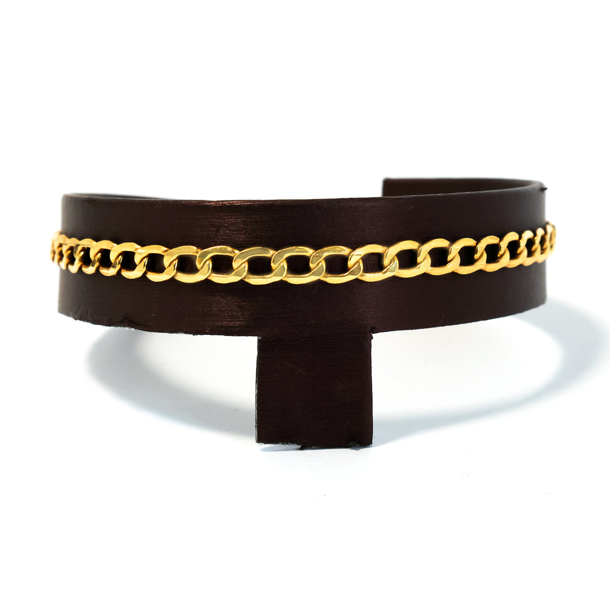 Black leather cuff with gold chain detail on a white background