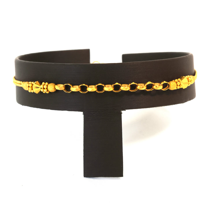 Black leather belt with gold chain detail on a white background
