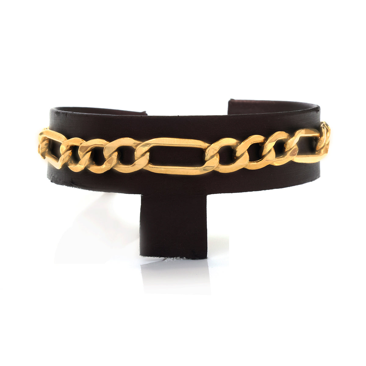 A gold chain-link cuff bracelet displayed on a black stand against a white background.