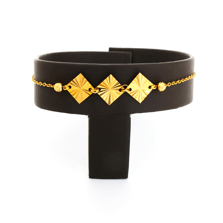 Black choker with gold geometric accents on a white background