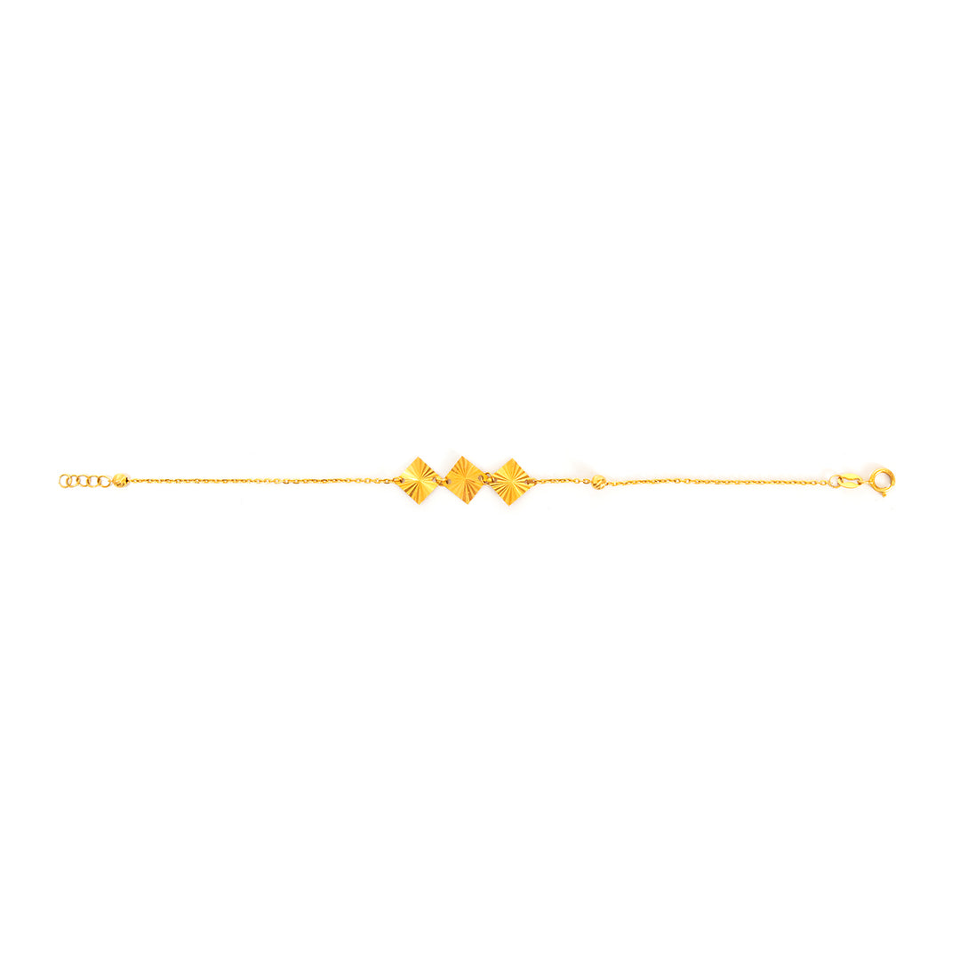 Gold bracelet with geometric designs on a white background