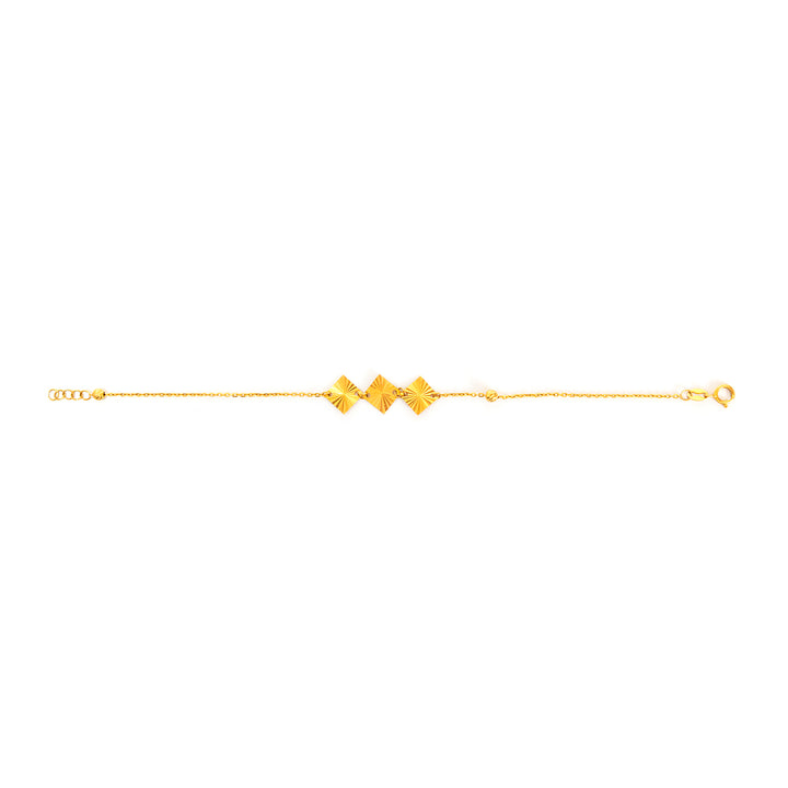 Gold bracelet with geometric designs on a white background