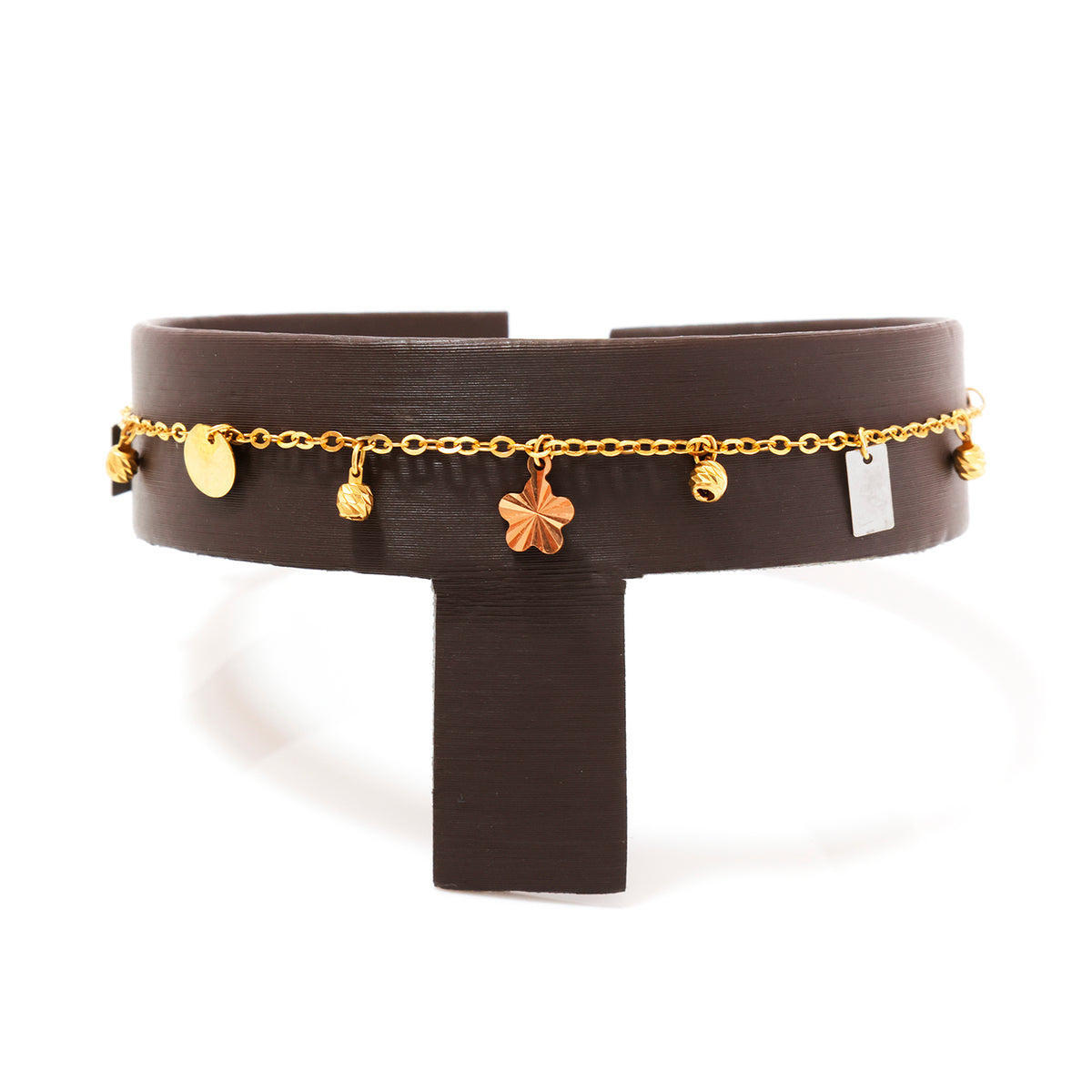 Black leather choker with gold chain and charms on a white background