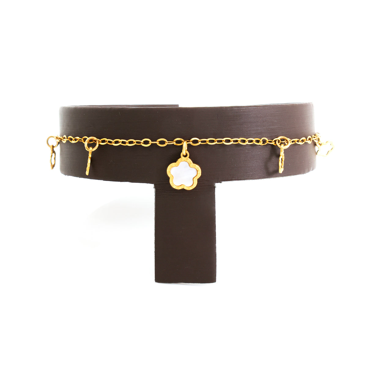 Brown leather choker with gold chain and charms on a white background