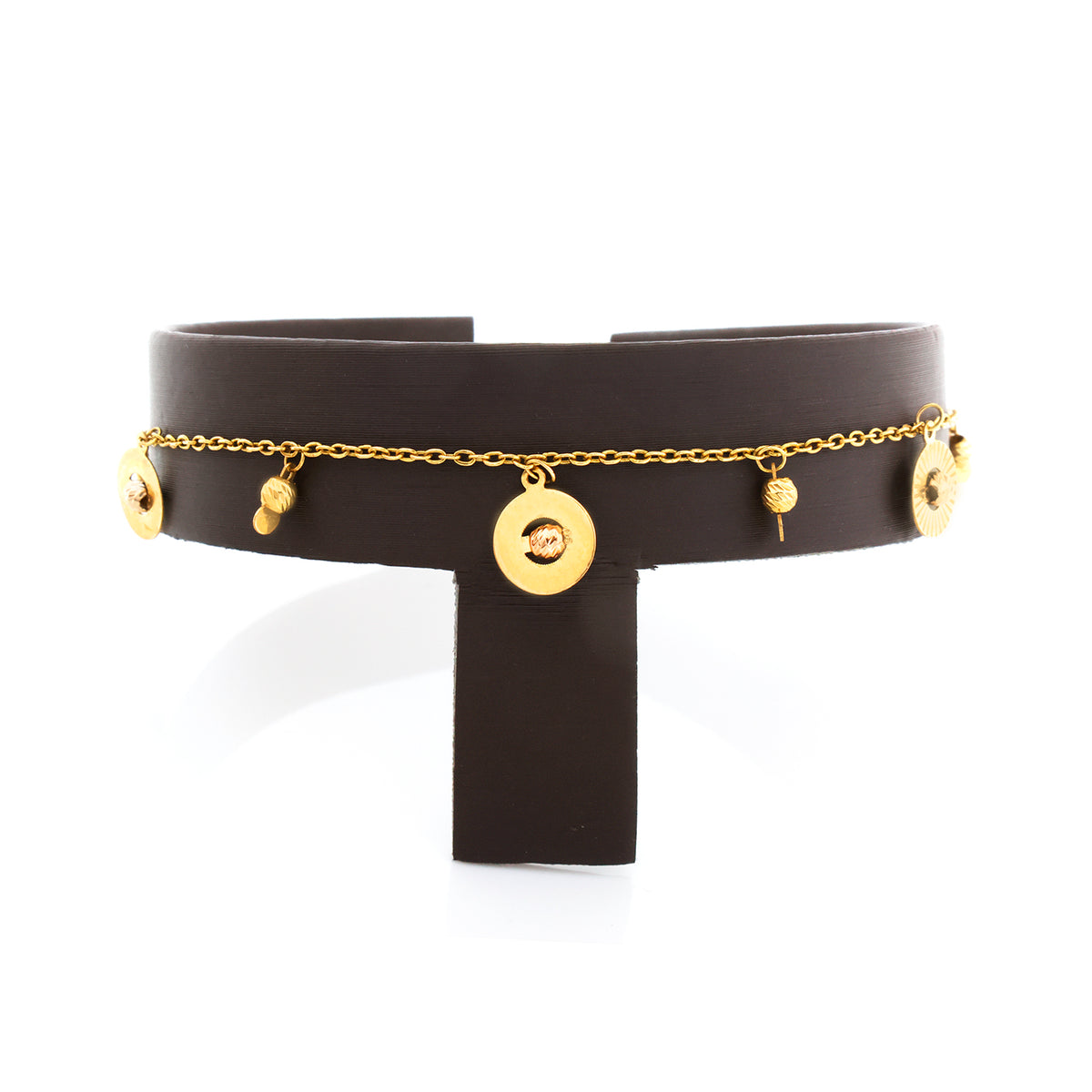 Black leather choker with gold chain and round pendants on a white background