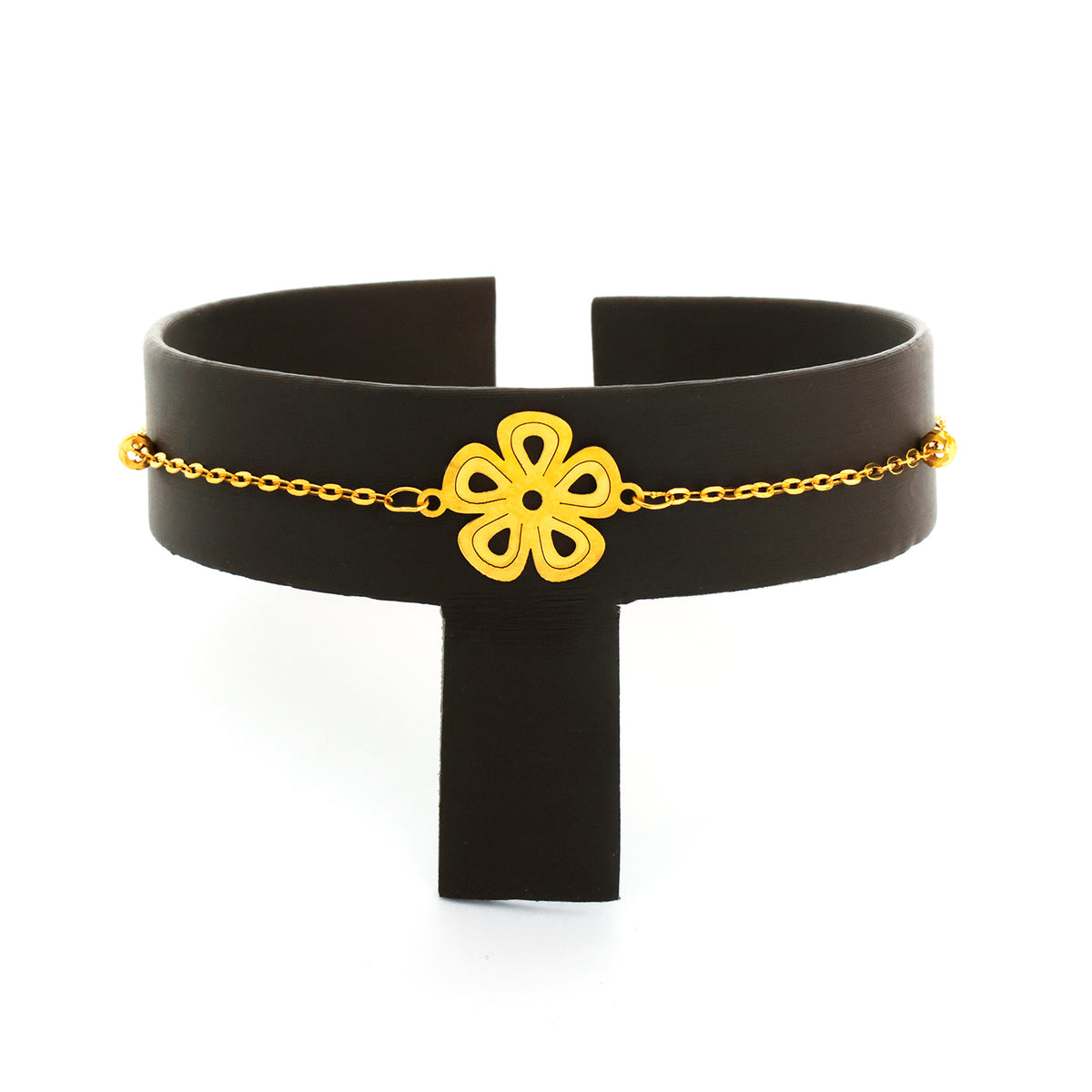Black choker with a yellow flower and chain on a white background