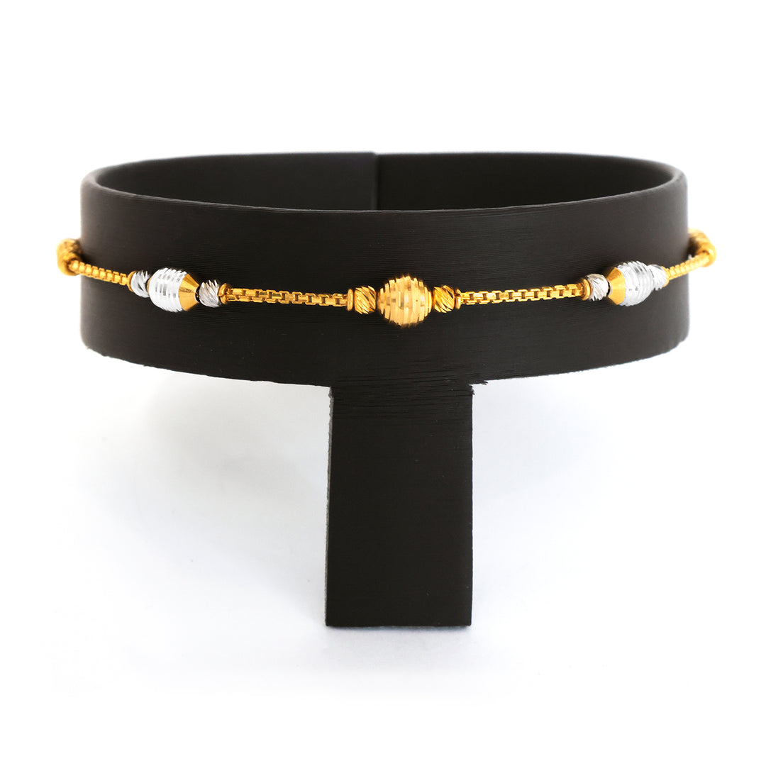 Black belt with gold and silver beaded chain on a white background
