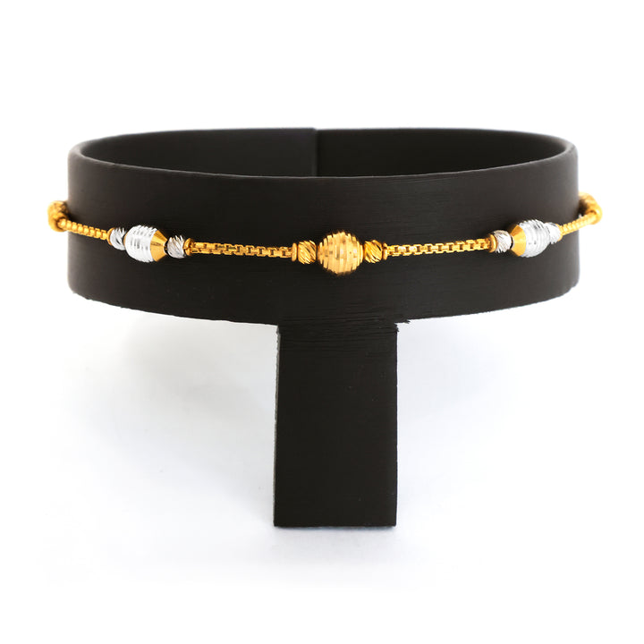 Black belt with gold and silver beaded chain on a white background