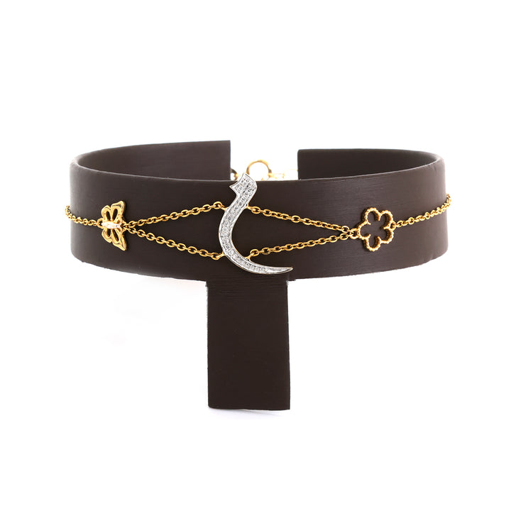 Black leather belt with gold and silver chain accessories on a white background