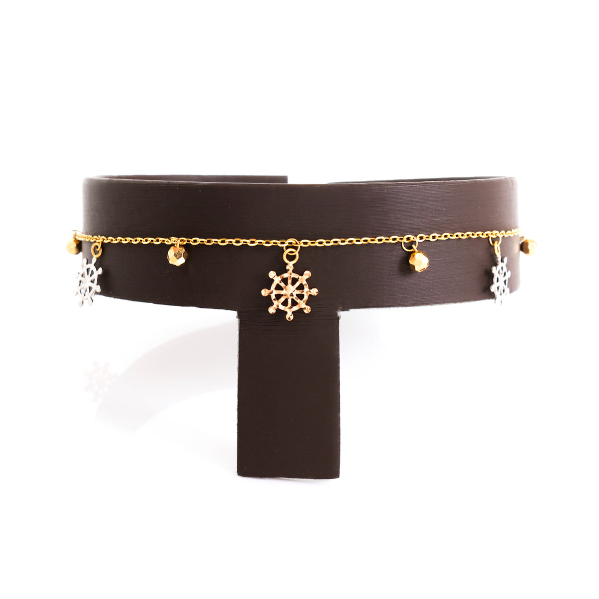 Black choker with gold chain and charms on a white background