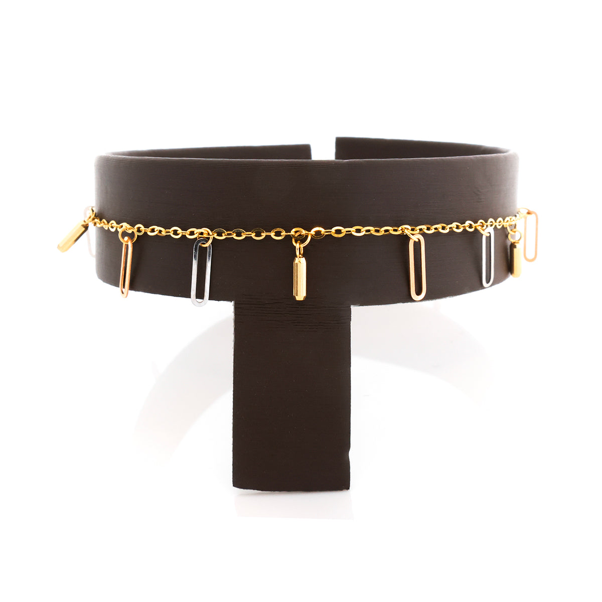 Black choker with gold chain and pendants on a white background
