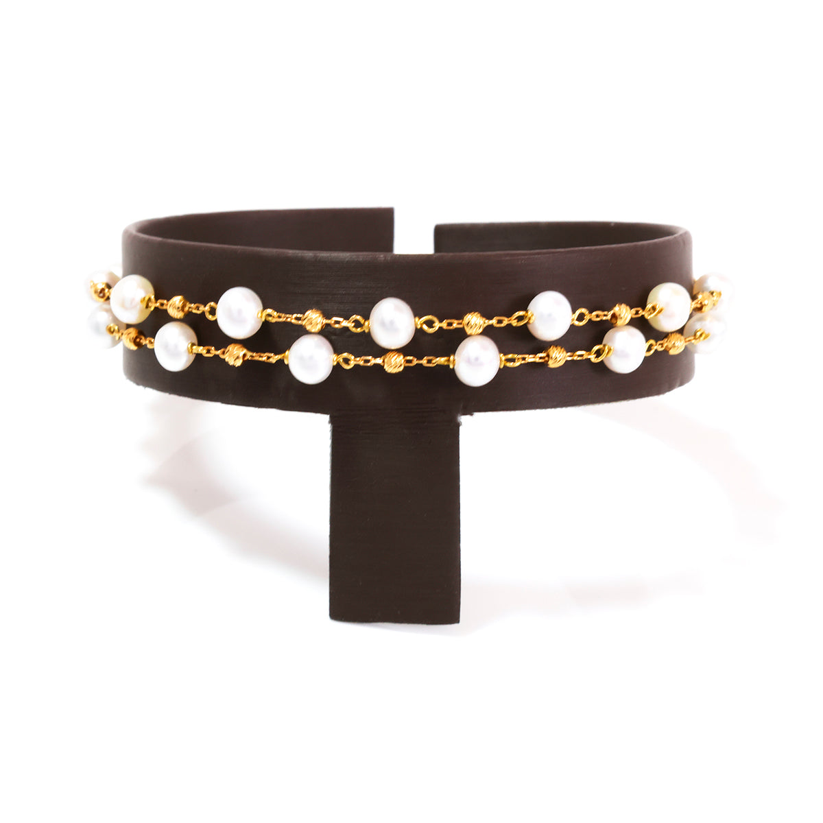 Black headband with gold chain and pearl-like beads on a white background