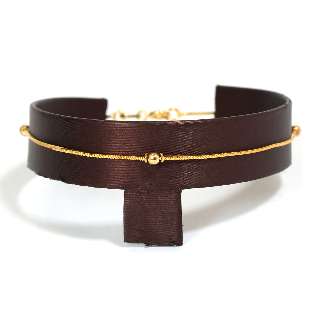 Brown leather choker with gold accents on a white background