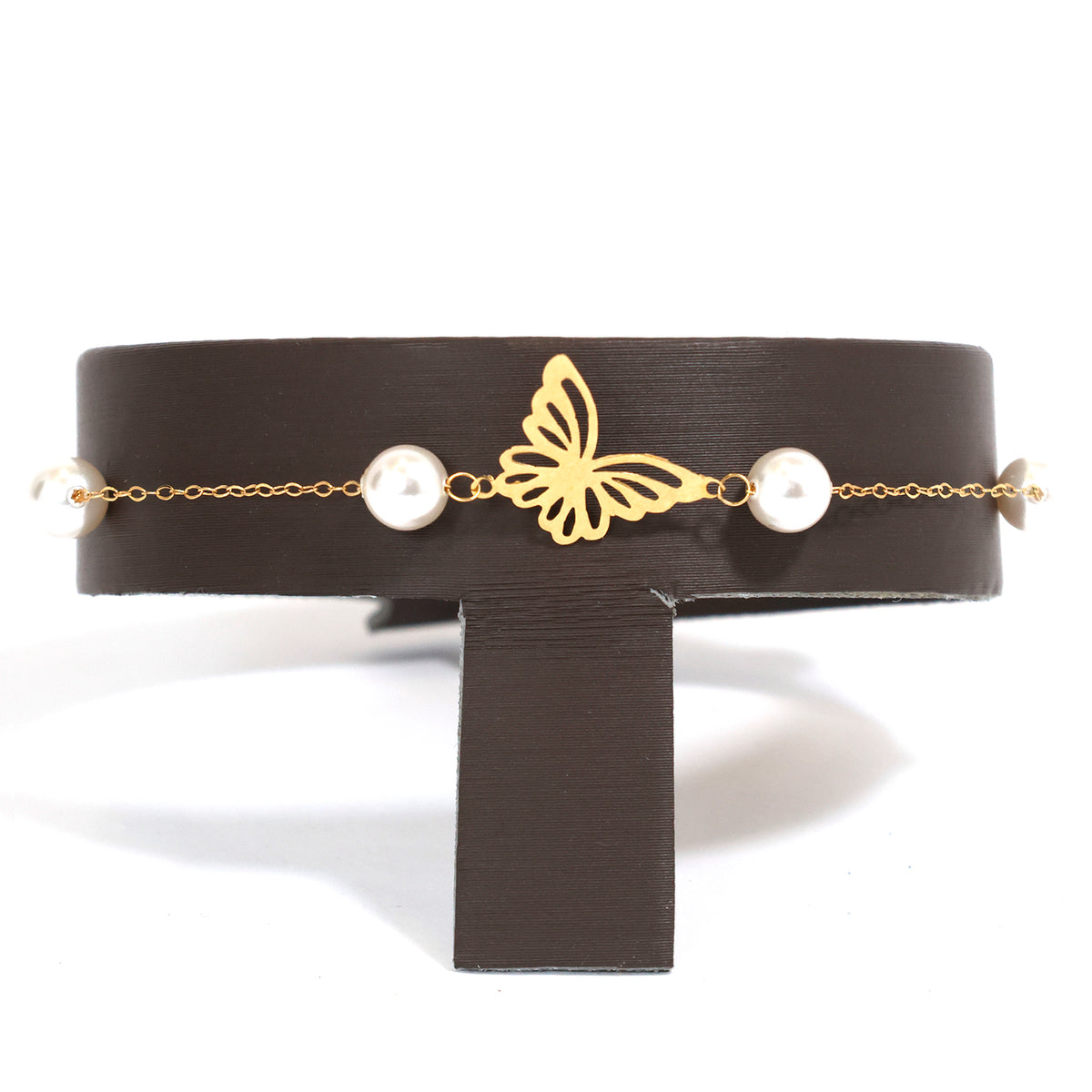 Black choker with gold butterfly and pearl accents on a white background