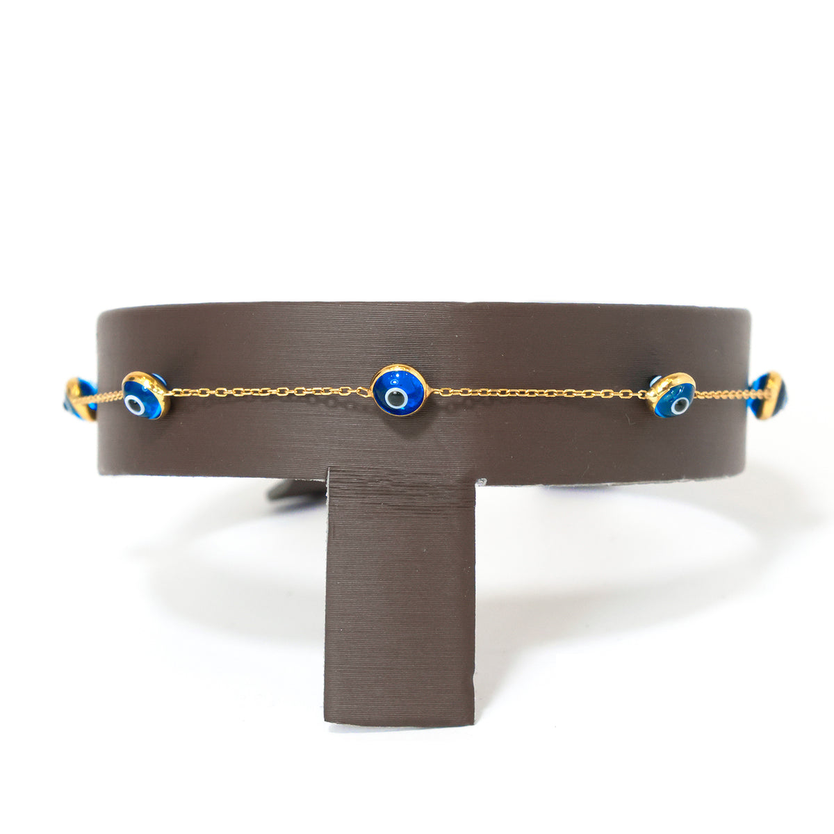 Belt with gold chain and blue evil eye charms on a white background