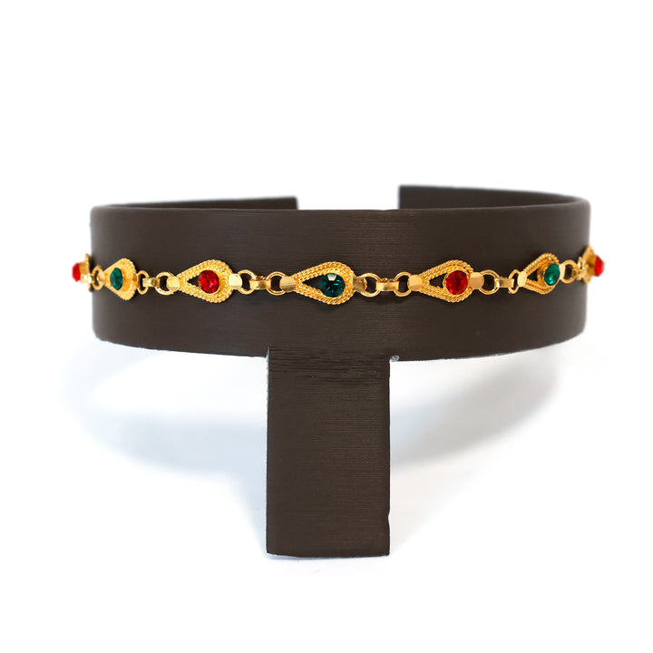 Black belt with gold chain and colored stones on a white background