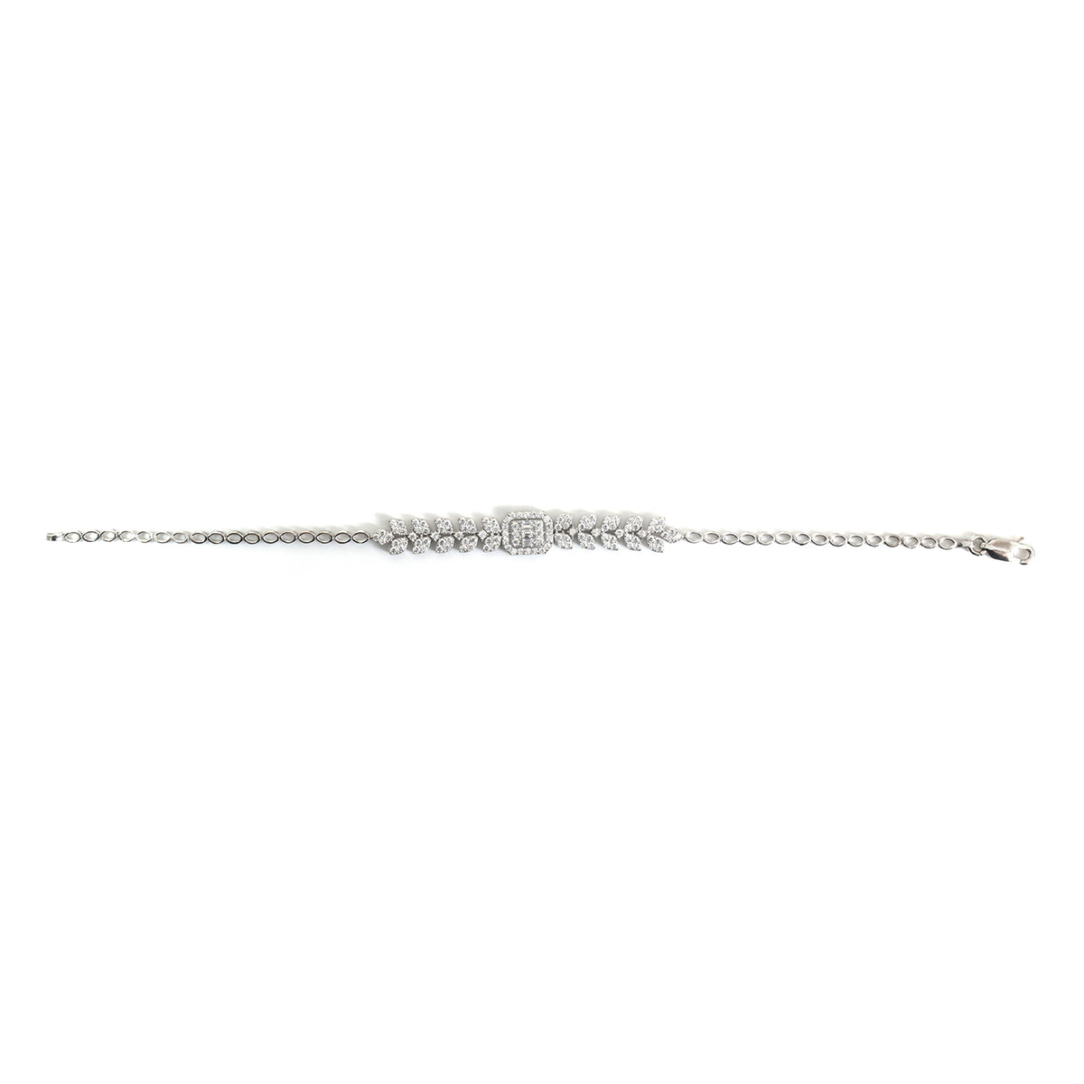 A delicate silver-toned chain bracelet featuring a central cluster of small round and emerald-cut stones, photographed against a solid white background.