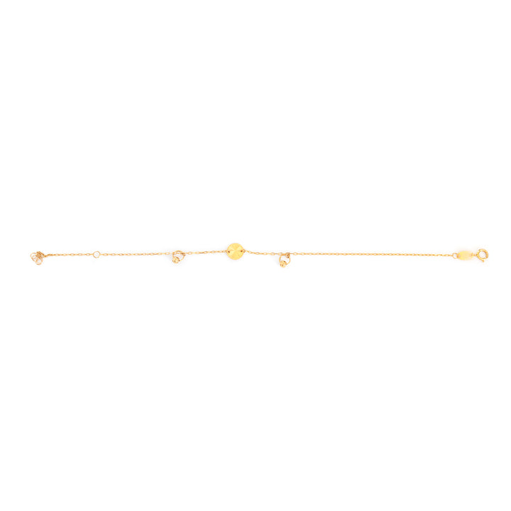 A delicate gold chain bracelet featuring a central round gold disc and small dangling gold charms, shown against a plain white background.