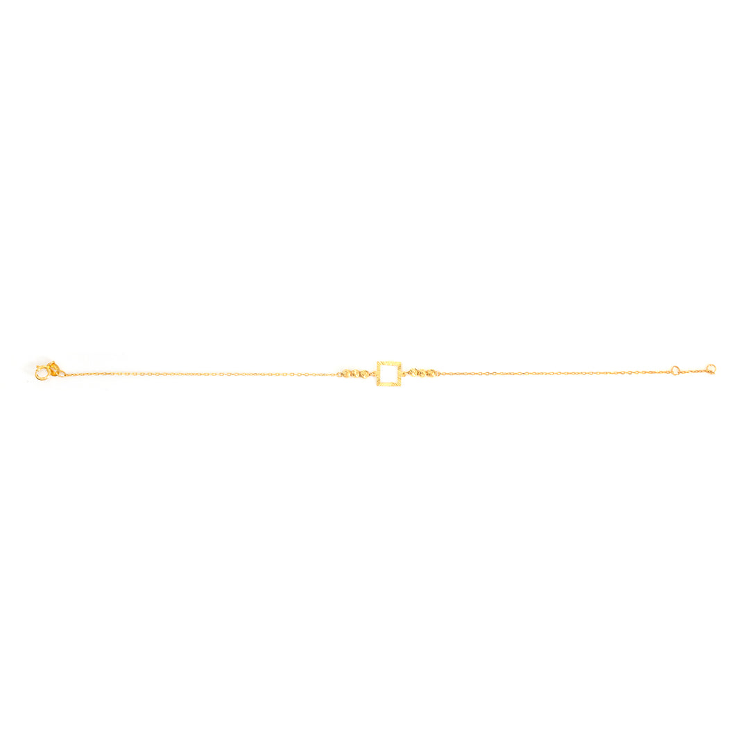 A delicate gold chain bracelet featuring a central open square charm, displayed horizontally against a solid white background.