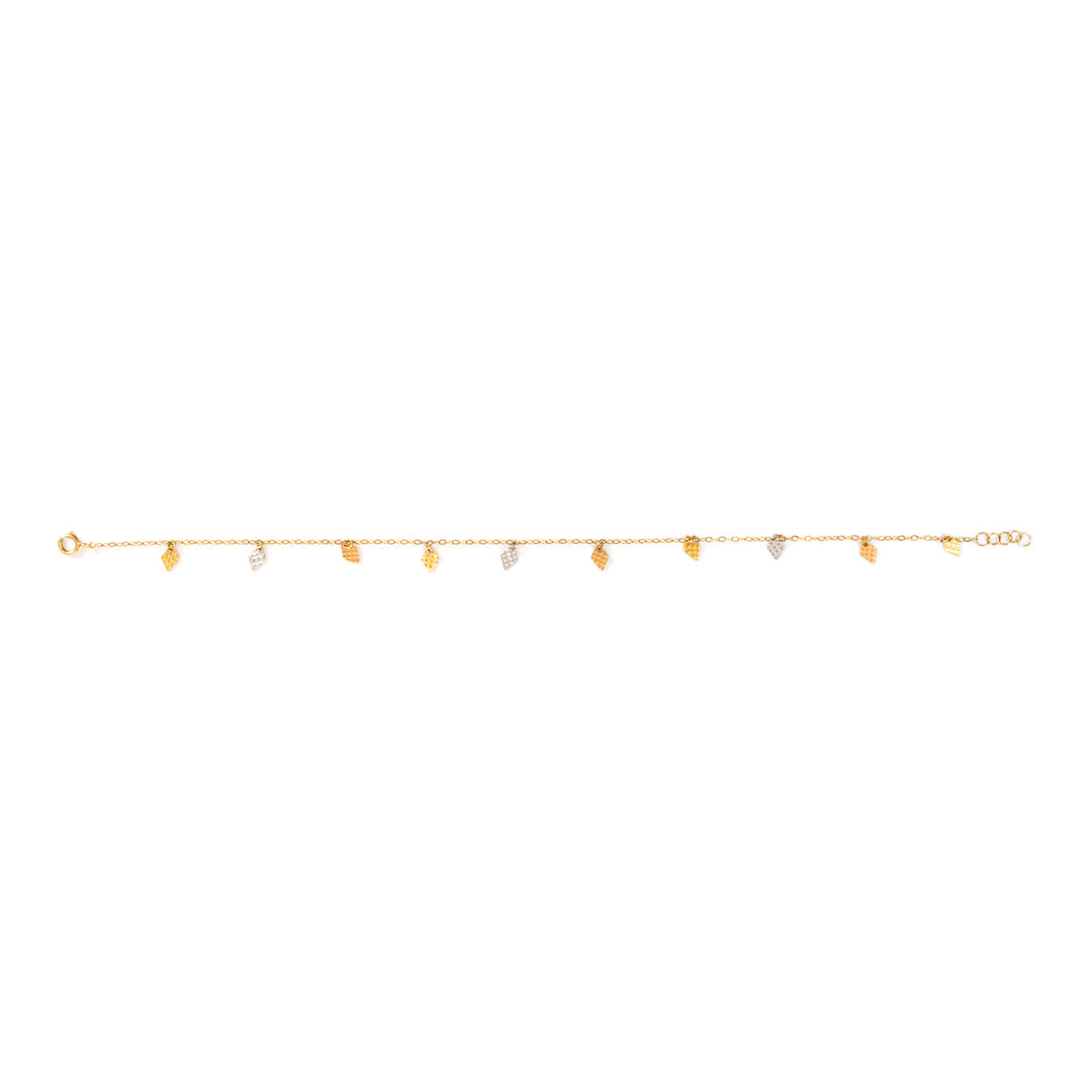 A delicate gold chain bracelet featuring small, irregular gold leaf charms and a few tiny clear stone accents, displayed horizontally against a solid white background.