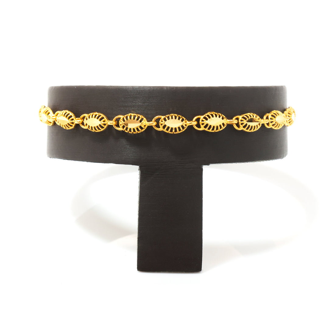 A gold chain bracelet with repeating sunburst or leaf-like links, displayed on a black T-stand against a white background.