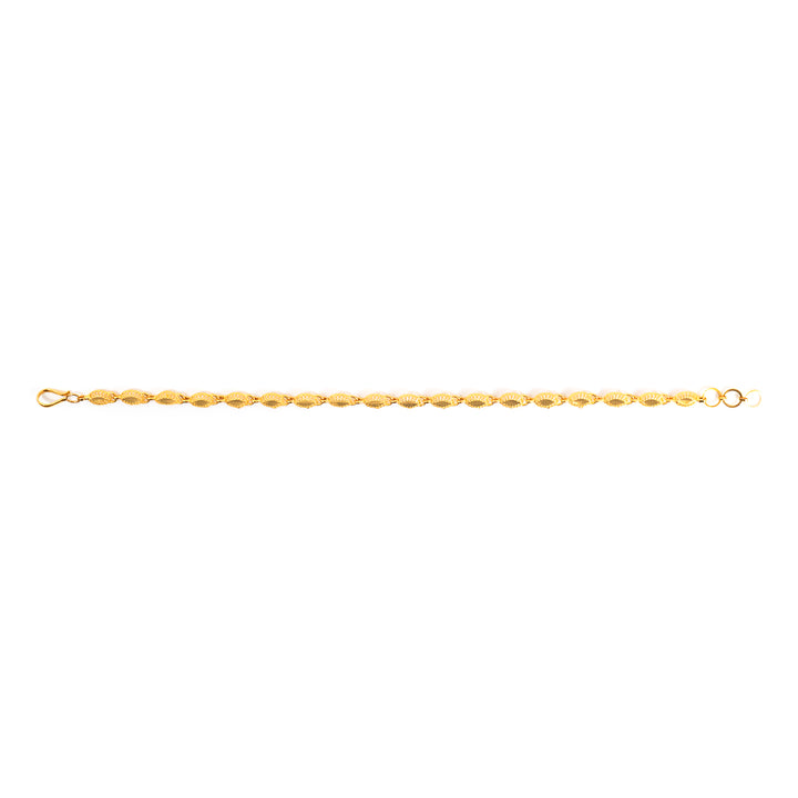 A delicate gold chain bracelet with faceted oval links, shown horizontally against a plain white background.