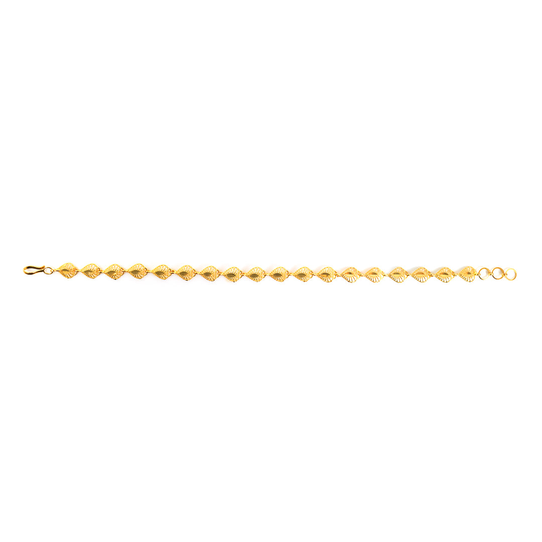 A delicate yellow gold tennis bracelet with faceted, diamond-shaped links, shown horizontally against a plain white background.