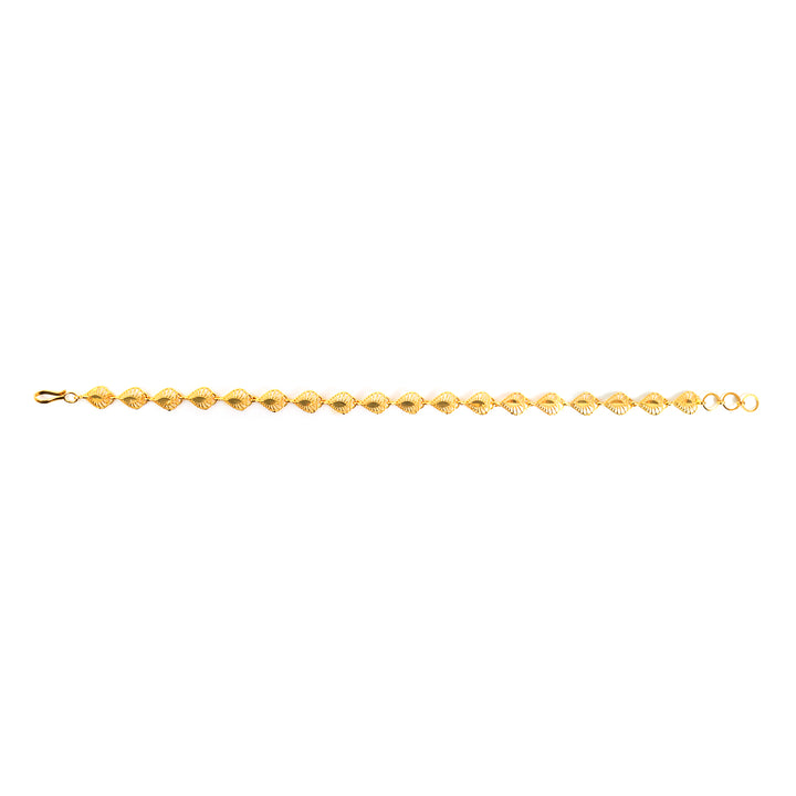 A delicate yellow gold tennis bracelet with faceted, diamond-shaped links, shown horizontally against a plain white background.