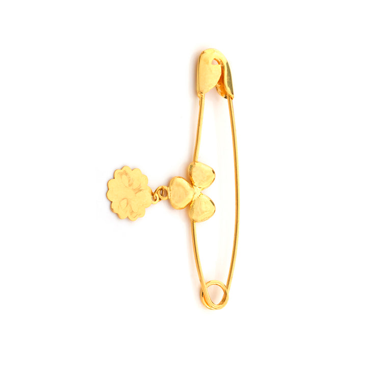 Gold safety pin earring with floral elements on a white background