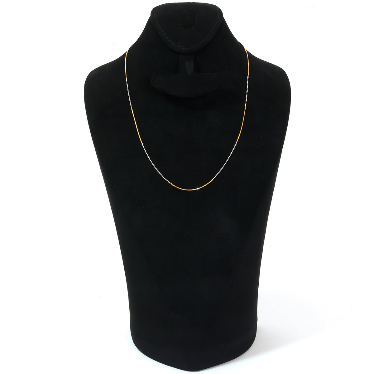 Gold necklace with a blue pendant on a black mannequin bust against a white background