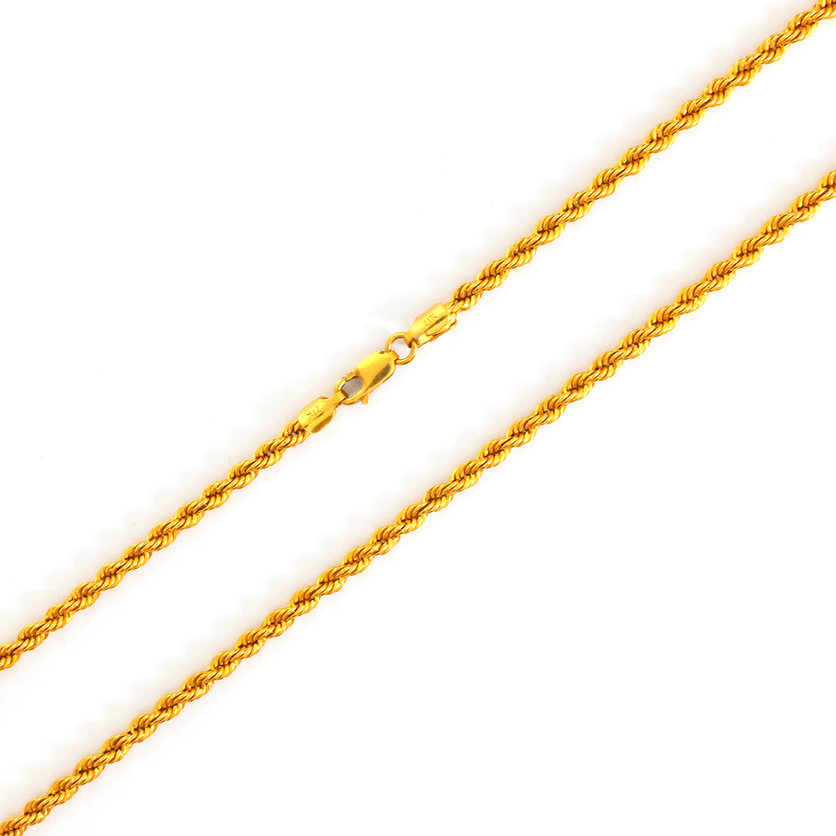 Gold rope chain necklace on a white background