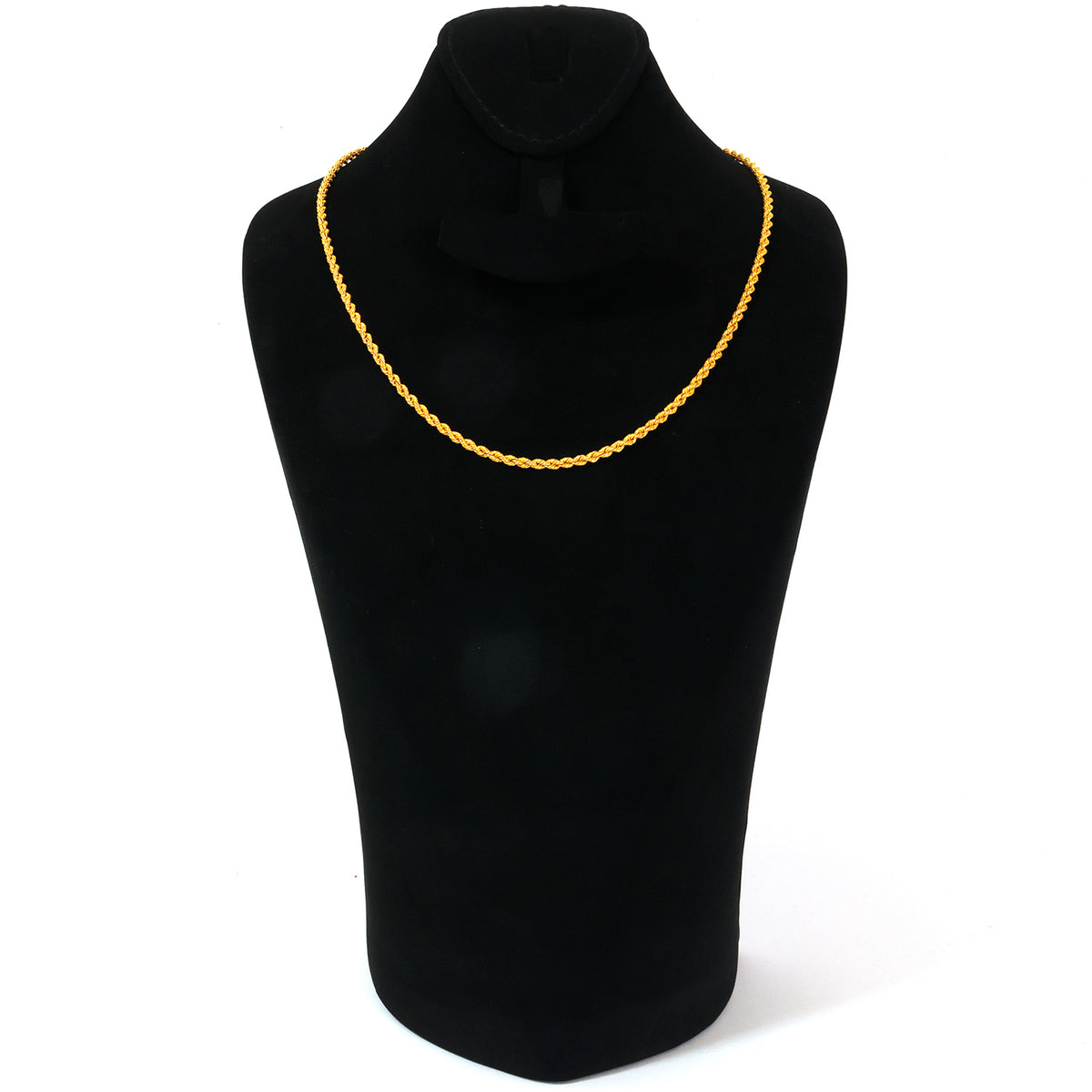 Black turtleneck sweater with a yellow necklace on a mannequin against a white background