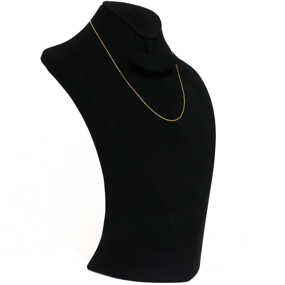 Gold necklace on a black mannequin bust against a white background