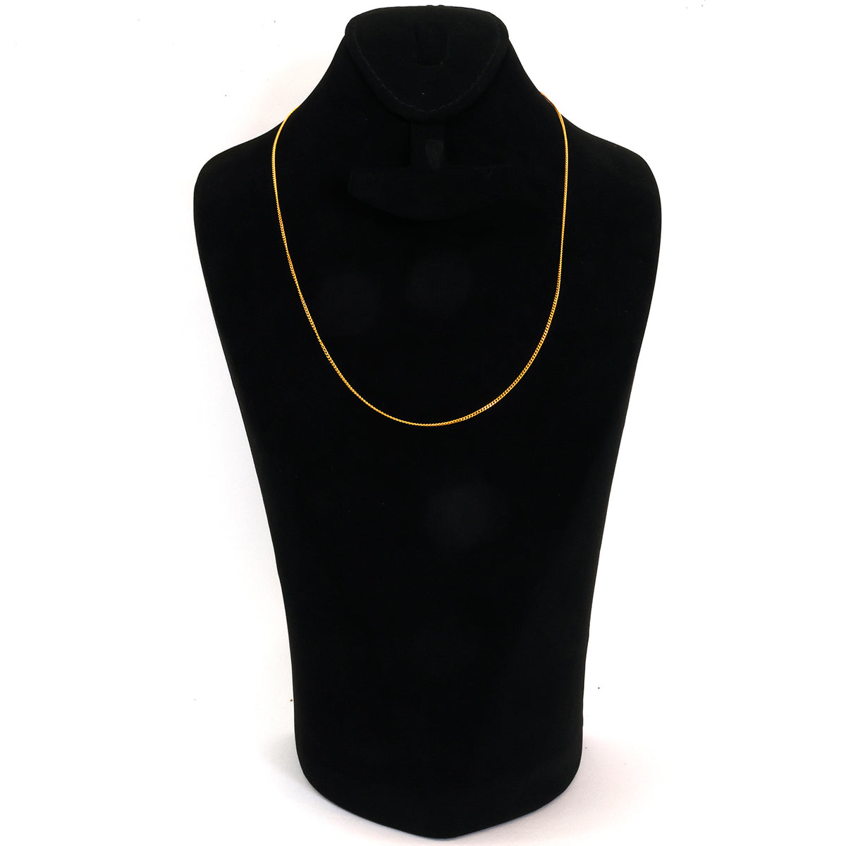 Black mannequin with a yellow necklace on a white background