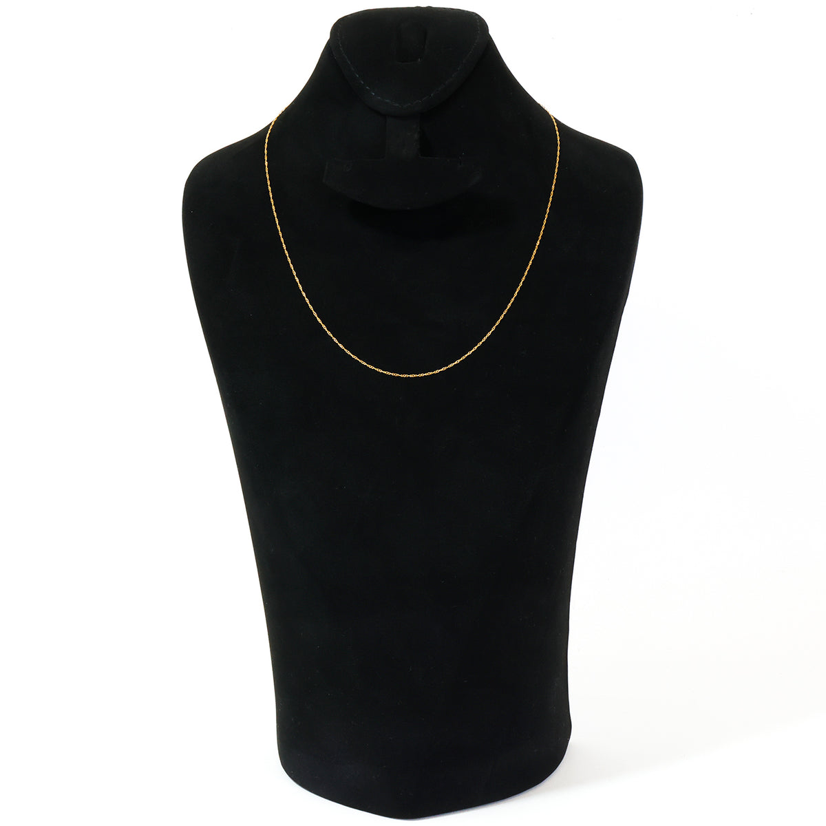 A delicate gold chain necklace displayed on a black velvet jewelry bust against a plain white background.