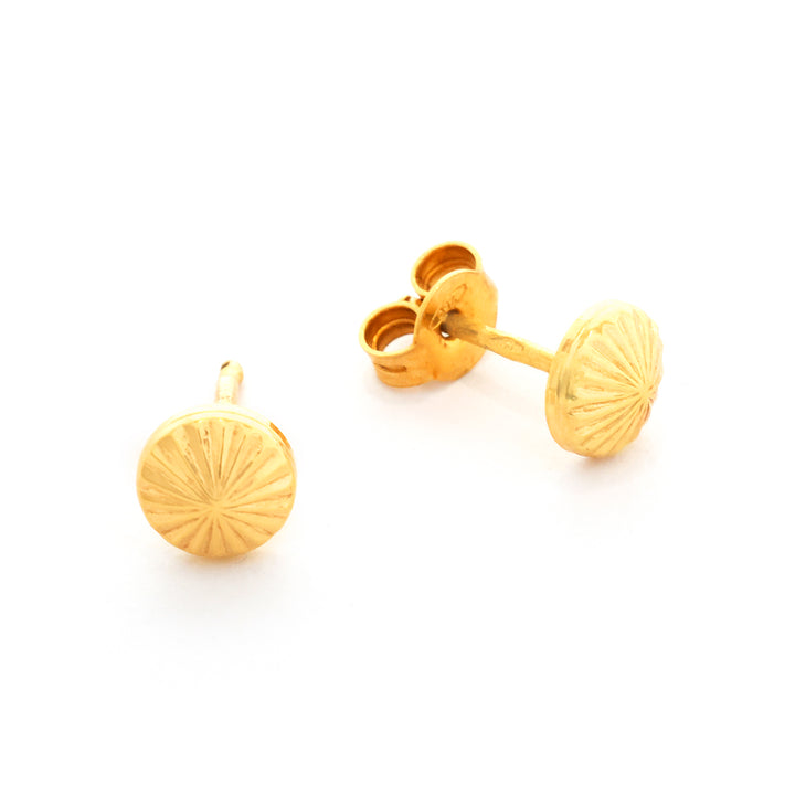 Pair of gold earrings on a white background