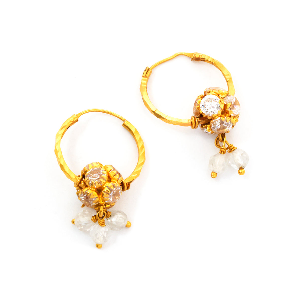 Gold hoop earrings with floral designs and pearl-like beads on a white background