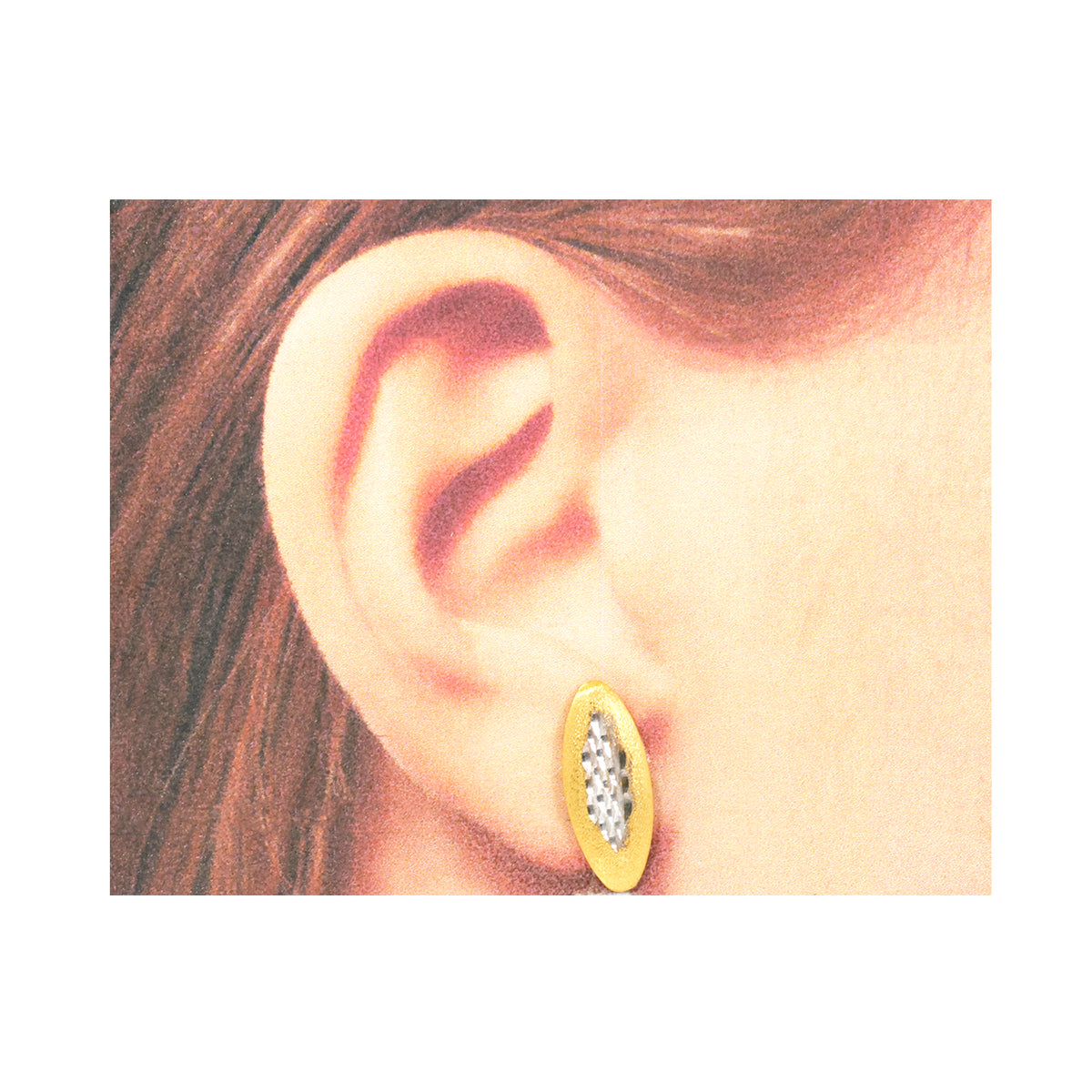 Gold earring with clear stones worn by a person