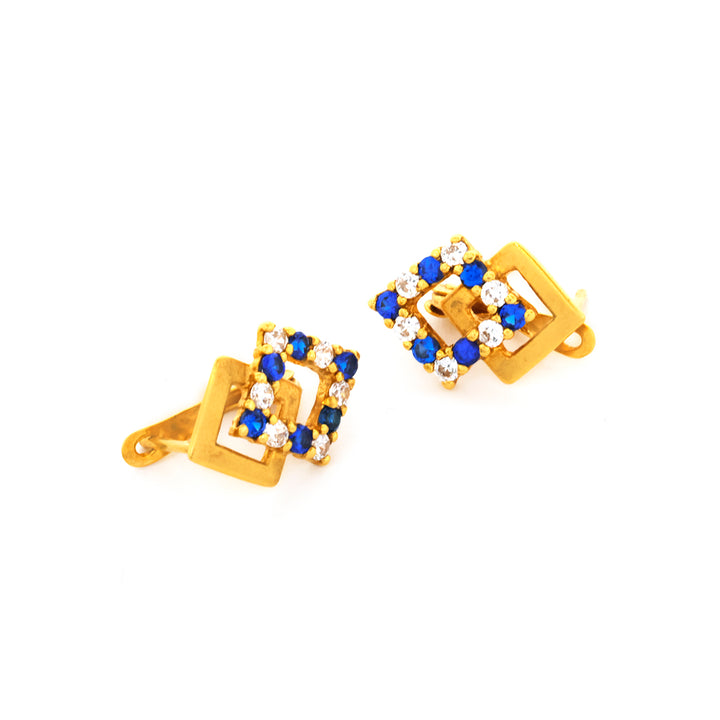 Gold cufflinks with blue and white gemstones on a white background