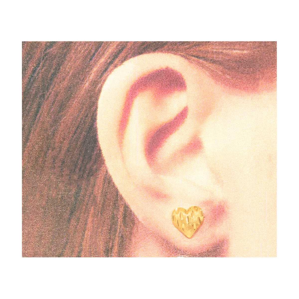 A close-up of a person's ear wearing a small textured gold heart-shaped stud earring, shown against a white border with a warm sepia-toned illustration style.