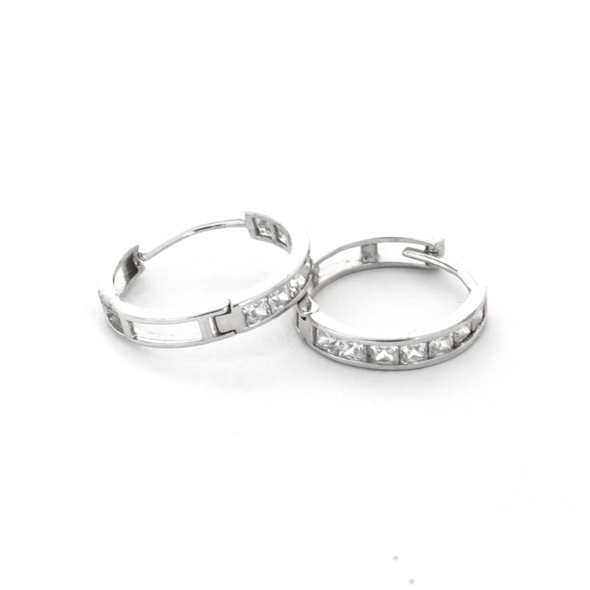 Silver hoop earrings with embedded stones on a white background