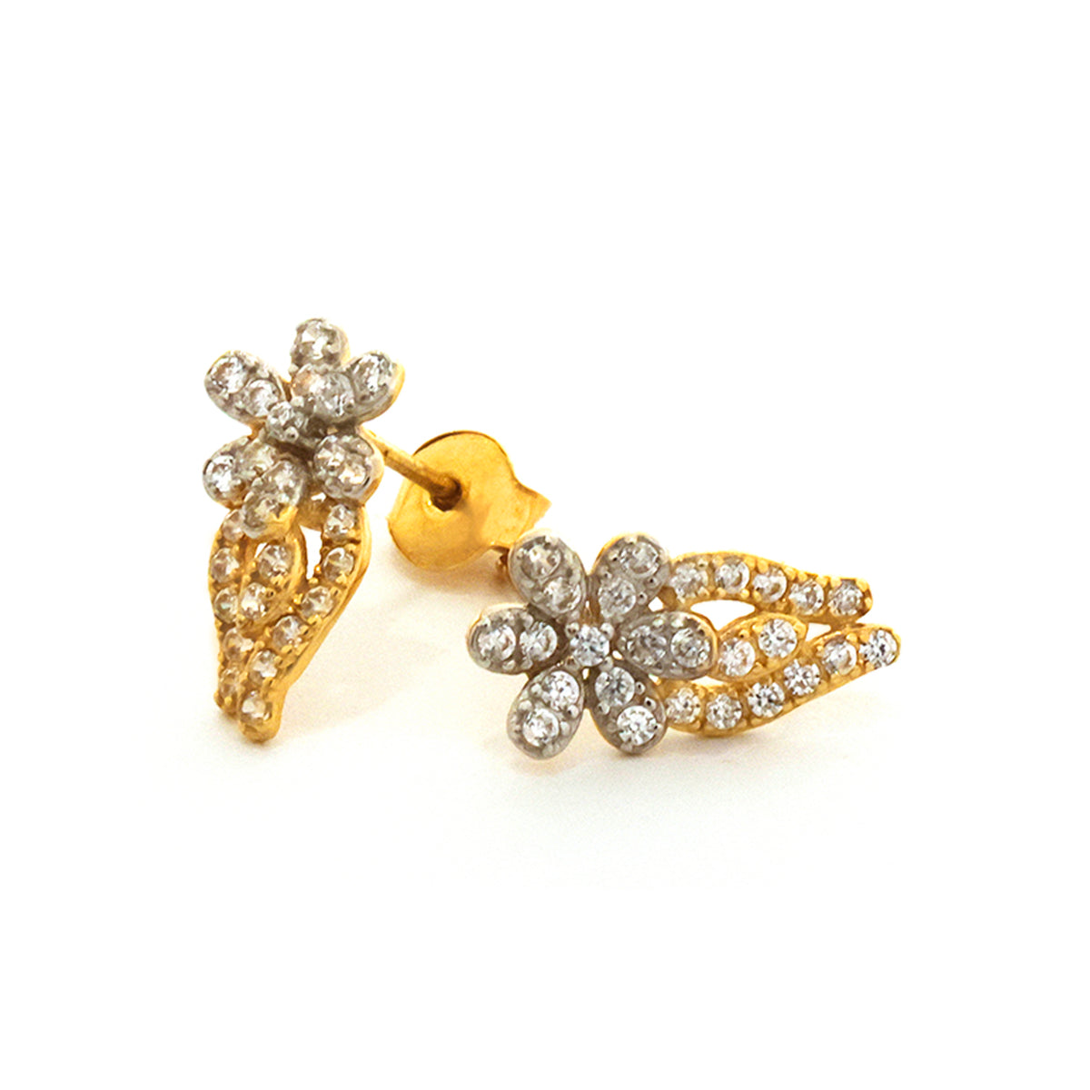 Gold earrings with leaf design and clear stones on a white background