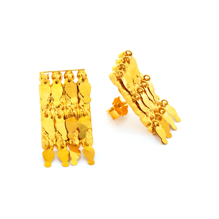 Gold earrings with dangling designs on a white background